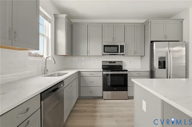 a kitchen with a sink stove and refrigerator