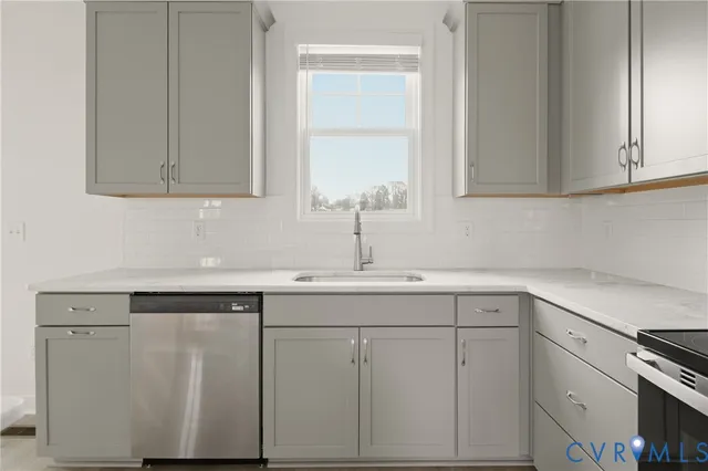 a sink with white cabinets