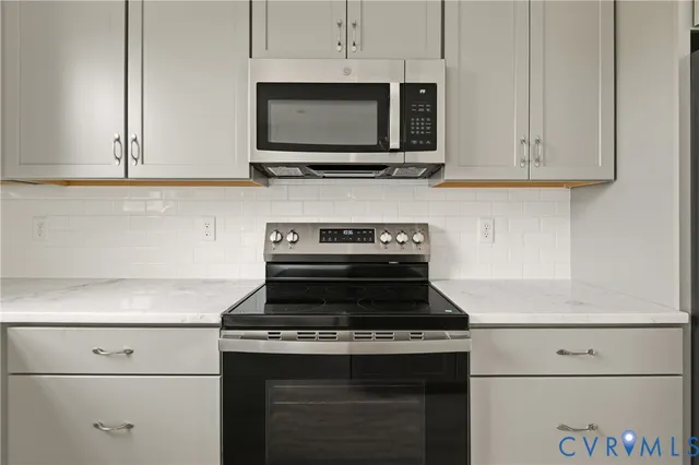 a stove top oven sitting inside of a kitchen