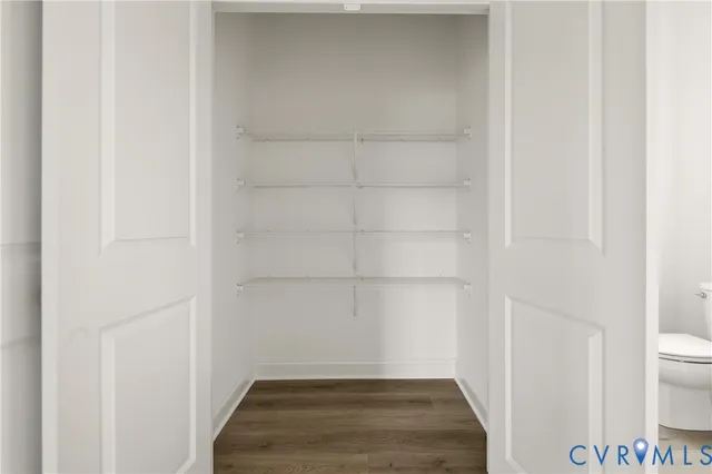 a view of a room with wooden floor