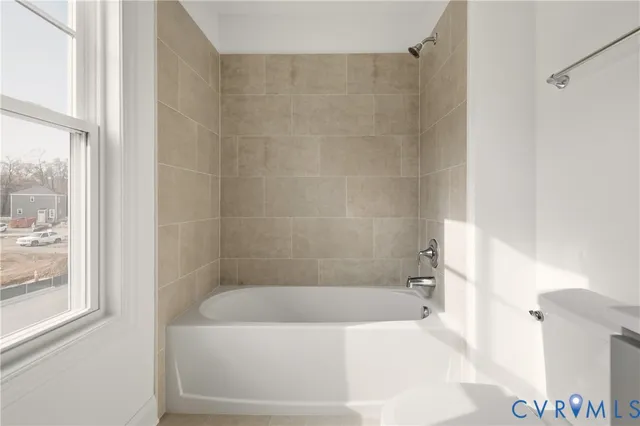 a white bath tub sitting next to a white sink