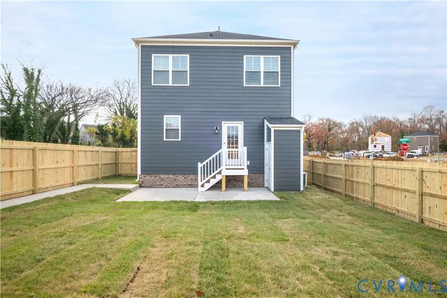 a view of a house with a yard and sitting area