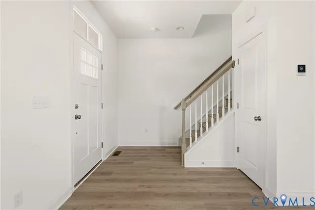 a view of an entryway with wooden floor