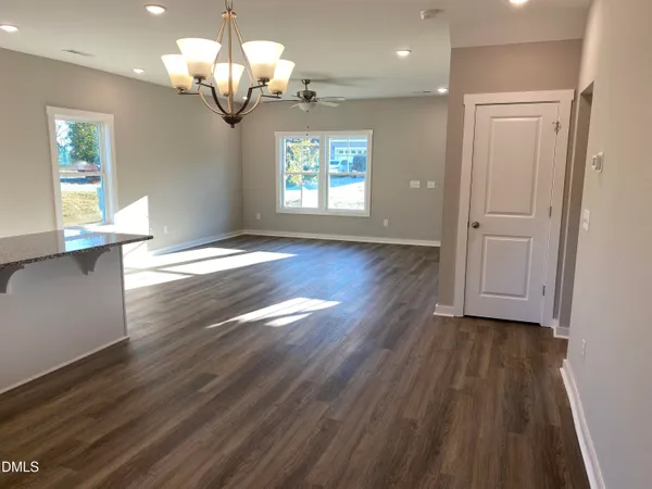 a kitchen with granite countertop a sink cabinets and stainless steel appliances