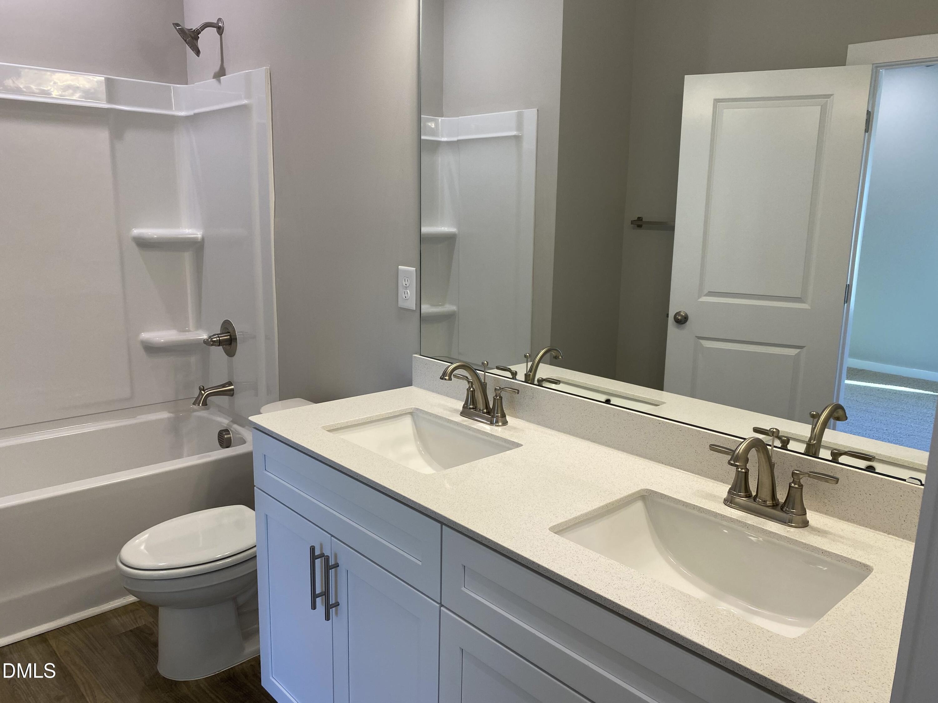 2827 Ricolden Trail Elon, NC 27244 - Photo 18 of 30 a bathroom with a granite countertop sink toilet and shower