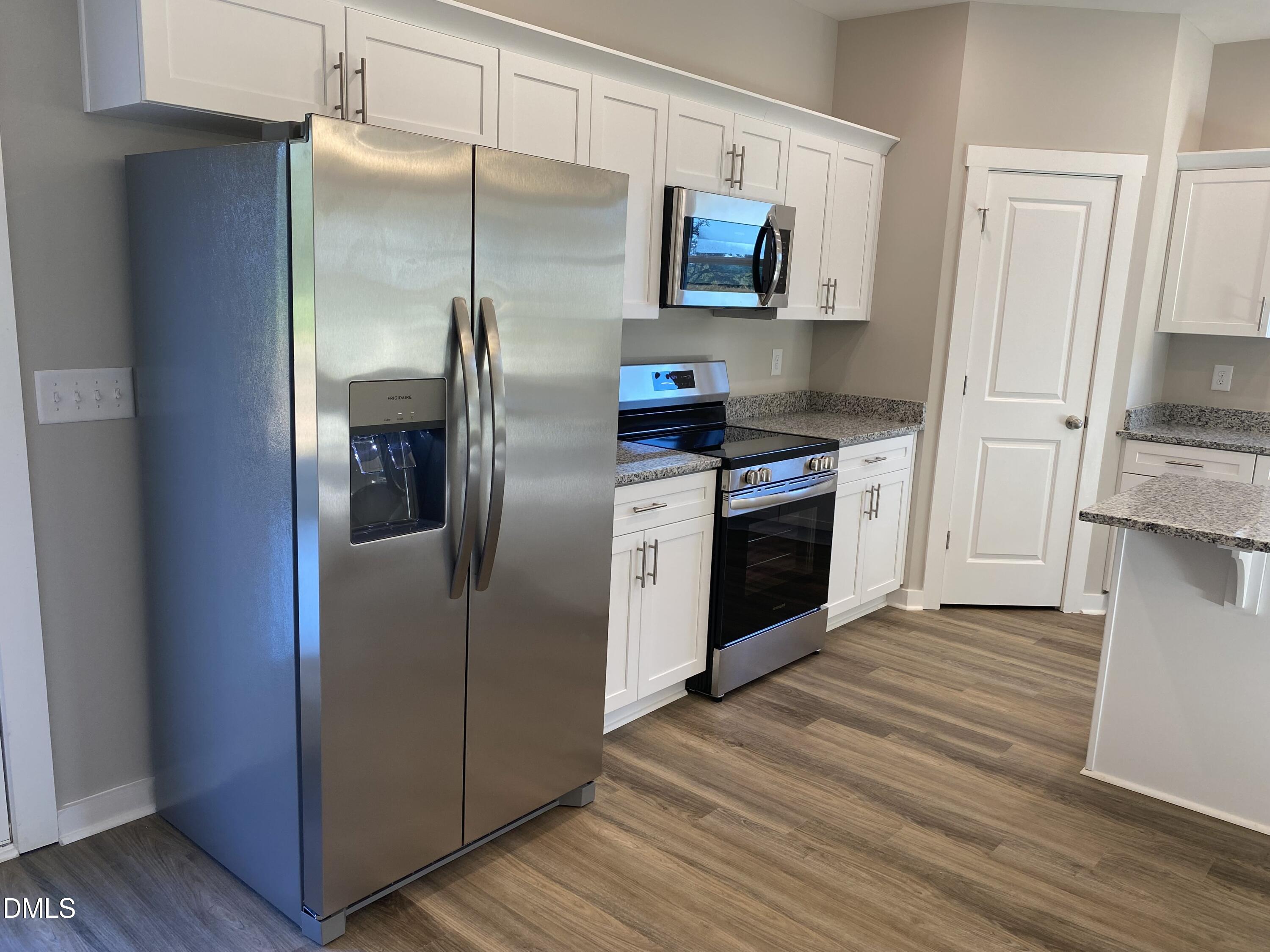 2827 Ricolden Trail Elon, NC 27244 - Photo 3 of 30 a kitchen with stainless steel appliances granite countertop a refrigerator and a stove top oven