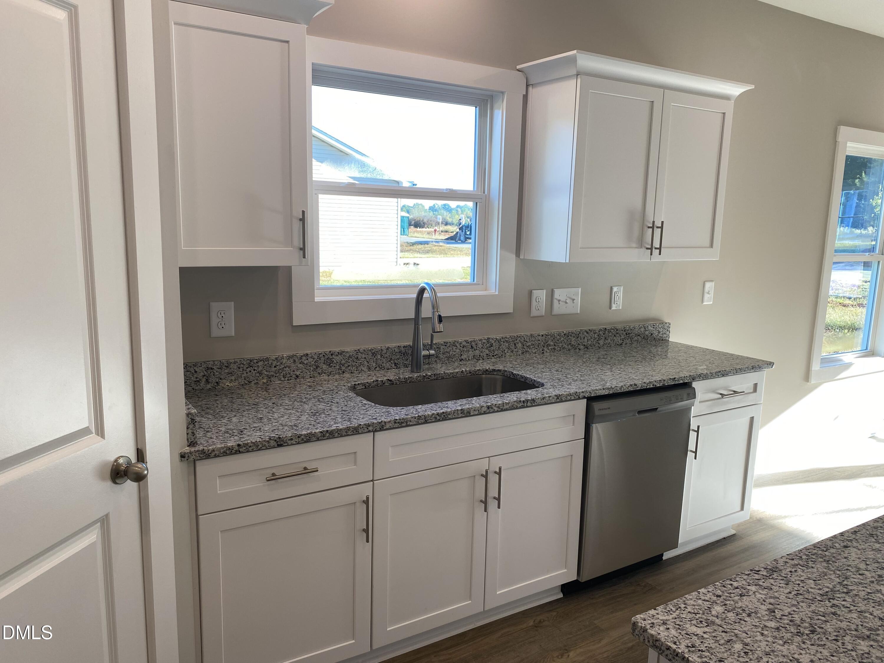2827 Ricolden Trail Elon, NC 27244 - Photo 7 of 30 a kitchen with granite countertop a sink and a window