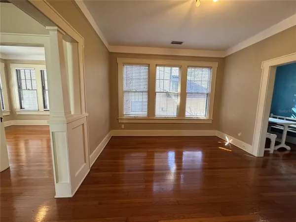 a view of a room with wooden floor and a window
