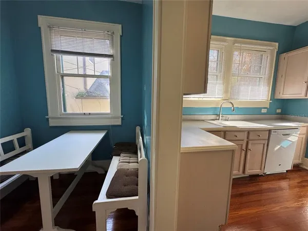 a kitchen with a sink a window and cabinets