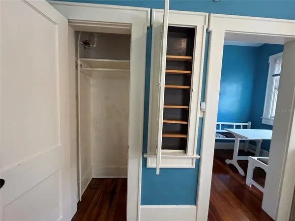 a view of walk in closet with empty racks