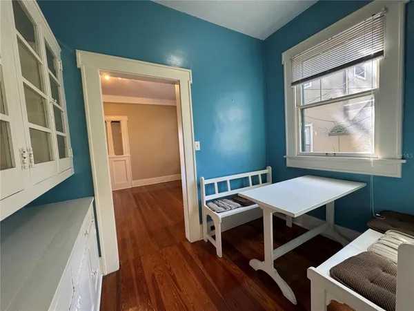 a view of a dining room with furniture window and wooden floor