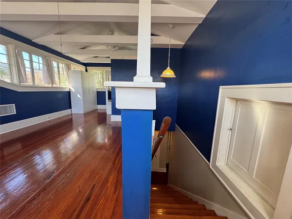 a view of entryway and hall with wooden floor