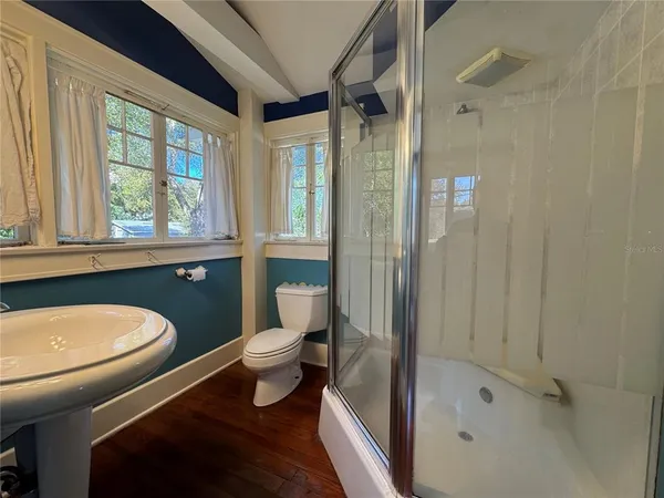 a bathroom with a toilet a sink and shower