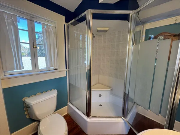 a bathroom with a toilet and a shower