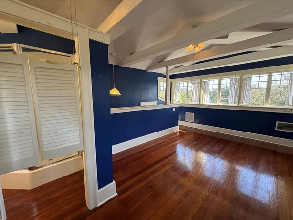 a view of room with wooden floor and staircase