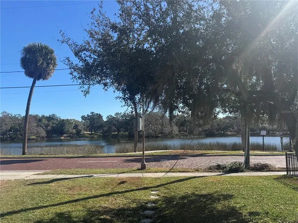 a view of a lake with large trees