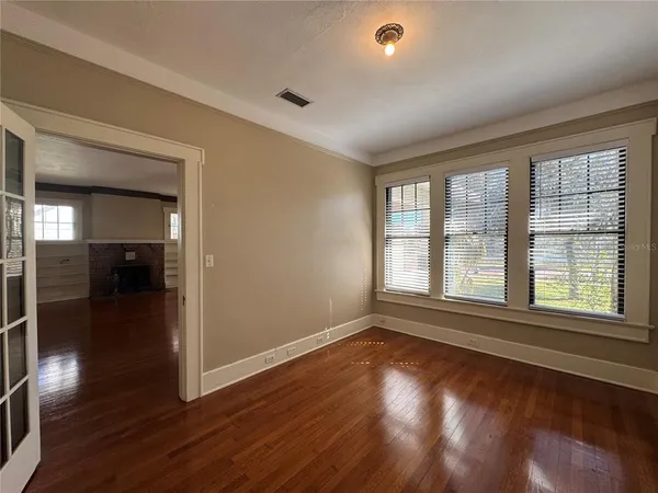 wooden floor in an empty room with a window