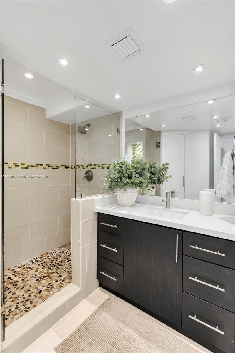 7135 Collins Avenue, Unit 1126 Miami Beach, FL 33141 - Photo 15 of 45 a bathroom with a sink and a mirror