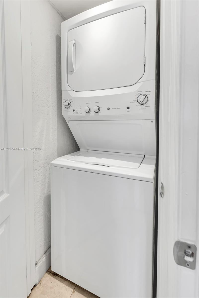 7135 Collins Avenue, Unit 1126 Miami Beach, FL 33141 - Photo 17 of 45 a close up view of a washer and dryer