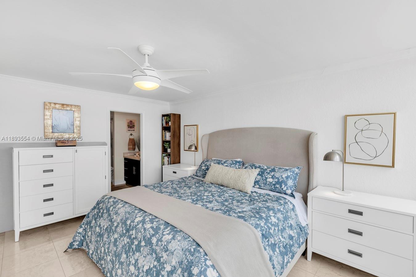 7135 Collins Avenue, Unit 1126 Miami Beach, FL 33141 - Photo 20 of 45 a bedroom with a large bed and a chandelier
