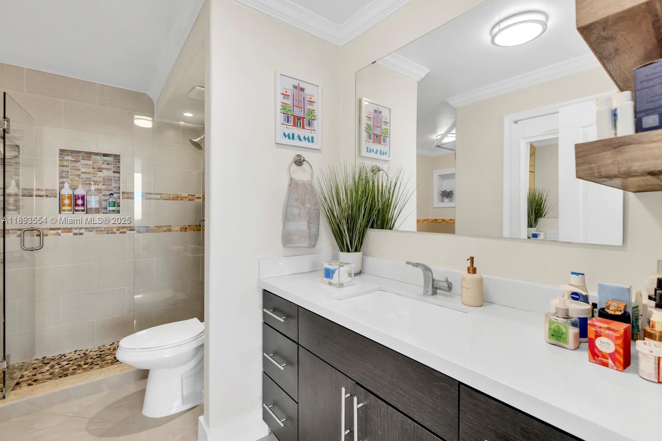 7135 Collins Avenue, Unit 1126 Miami Beach, FL 33141 - Photo 21 of 45 a bathroom with a sink a toilet and a mirror