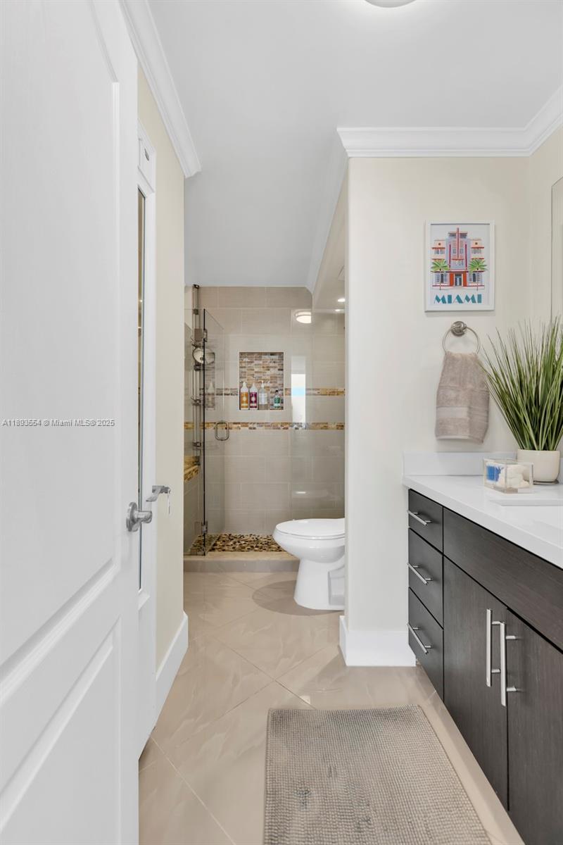 7135 Collins Avenue, Unit 1126 Miami Beach, FL 33141 - Photo 22 of 45 a bathroom with a sink a toilet and shower