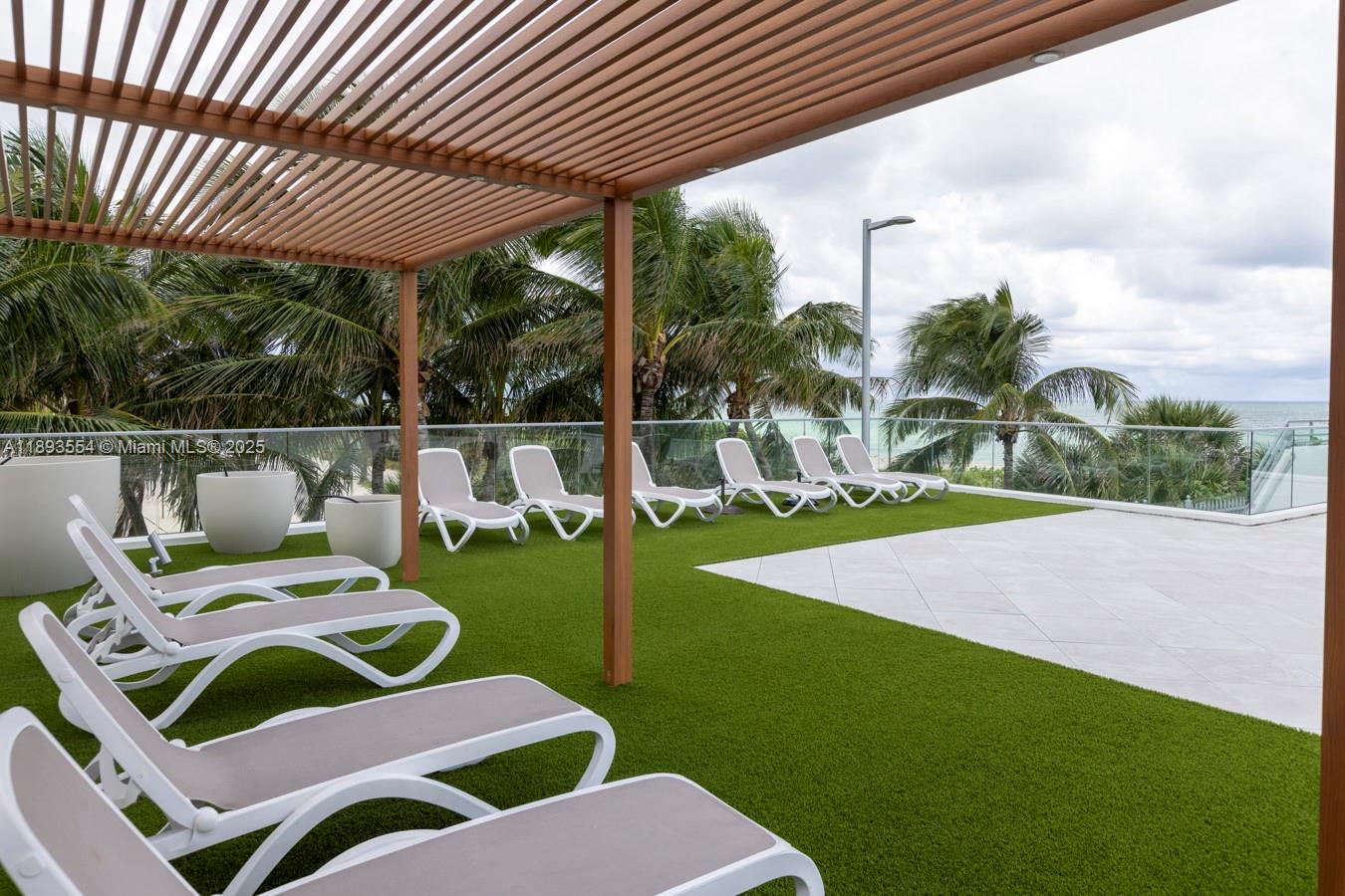 7135 Collins Avenue, Unit 1126 Miami Beach, FL 33141 - Photo 27 of 45 a view of a patio with chairs and table in the patio