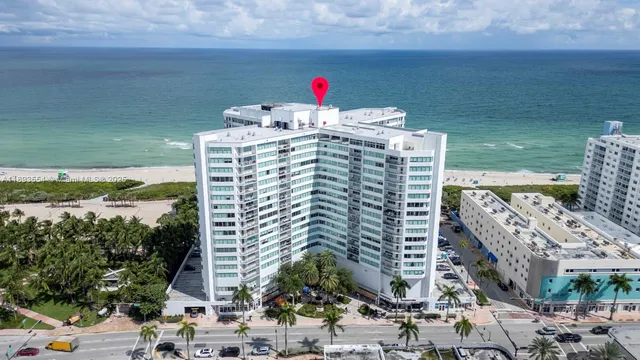 a view of a pathway both side of grassy field with shrub