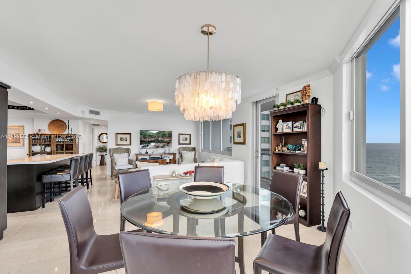 7135 Collins Avenue, Unit 1126 Miami Beach, FL 33141 - Photo 7 of 45 a dining room with furniture a rug and wooden floor