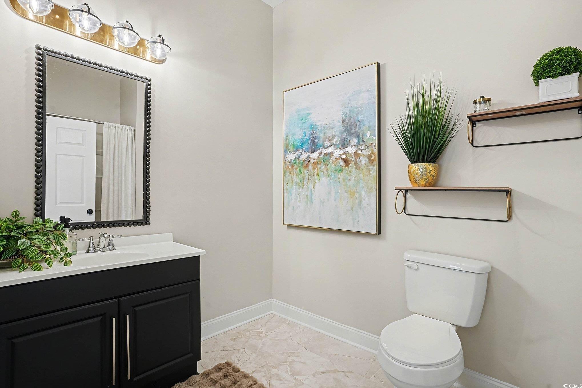 3741 Ed Smith Avenue Myrtle Beach, SC 29588 - Photo 21 of 38 Full bath featuring vanity, light marble finish flooring, and a shower with curtain