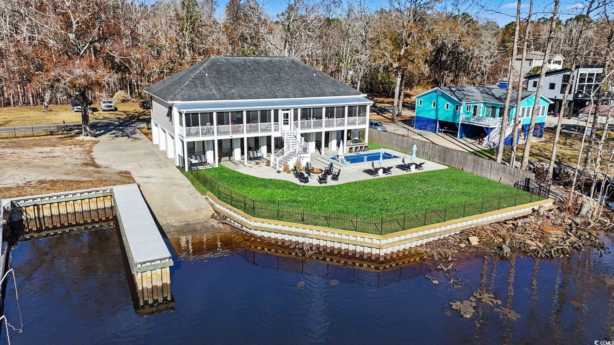 3741 Ed Smith Avenue Myrtle Beach, SC 29588 - Photo 3 of 38 Rear view of house with a patio area, a fenced backyard, a water view, a shingled roof, and stairs