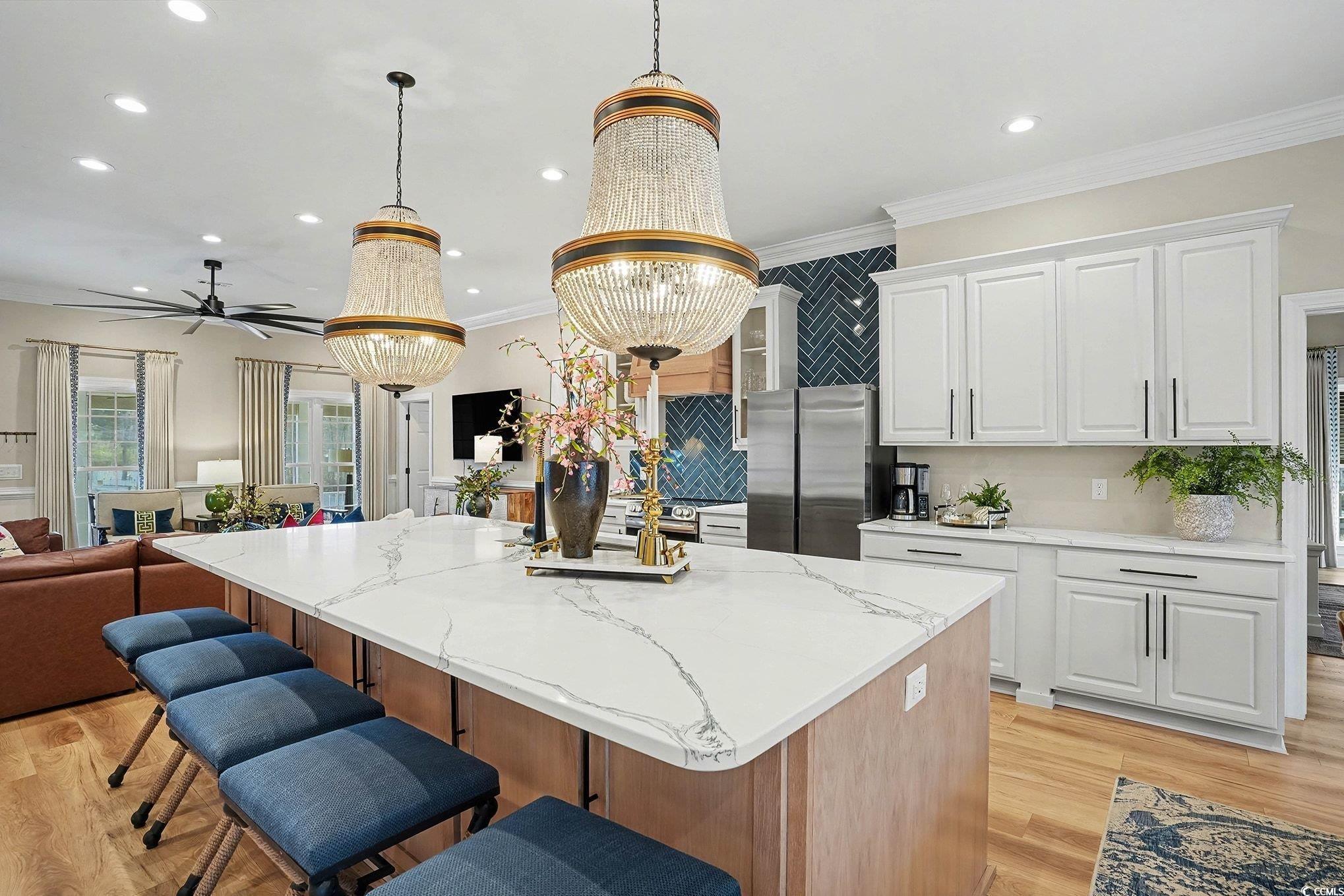 3741 Ed Smith Avenue Myrtle Beach, SC 29588 - Photo 38 of 38 Kitchen with open floor plan, white cabinetry, a kitchen bar, light stone counters, and recessed lighting