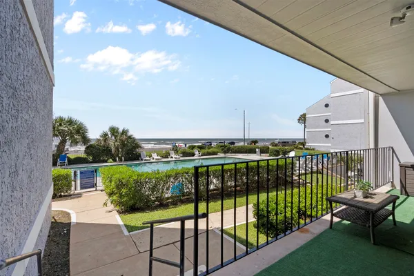 a view of a balcony with furniture