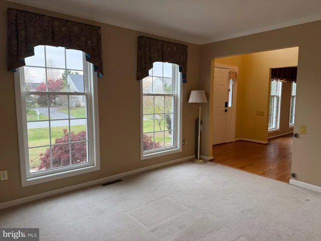 a view of a hallway with wooden floor and stairs