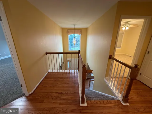 an empty room with closet and a chandelier fan