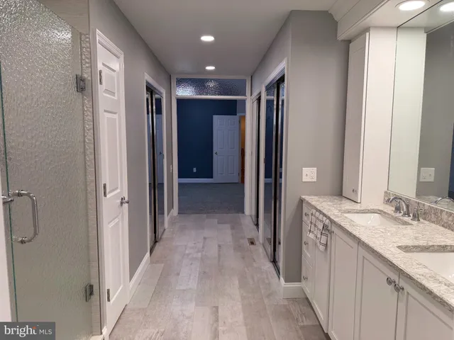 a view of an empty room and chandelier fan