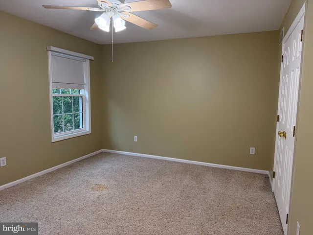 a bathroom with a granite countertop sink a mirror and a bathtub