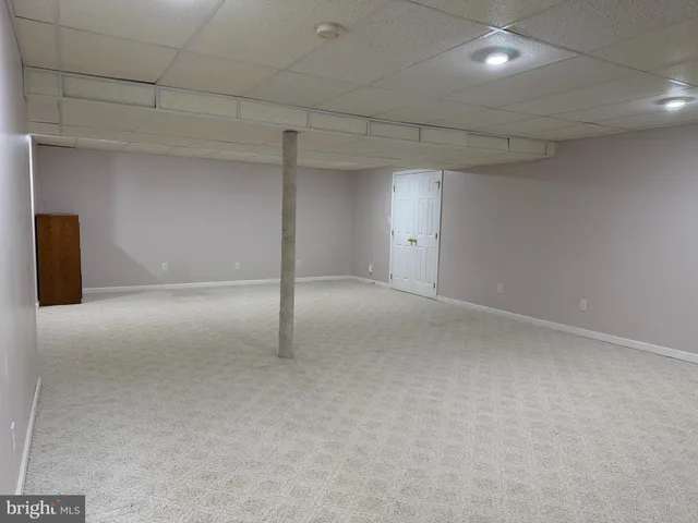 an empty room with a window and wooden floor