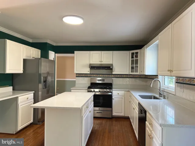 a kitchen with a sink stove and refrigerator