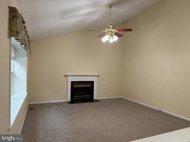 a view of empty room with a fireplace