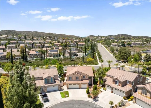 an aerial view of residential houses with outdoor space and ocean view