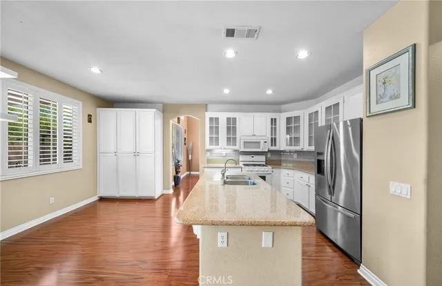 a kitchen with stainless steel appliances granite countertop white cabinets and a granite counter tops