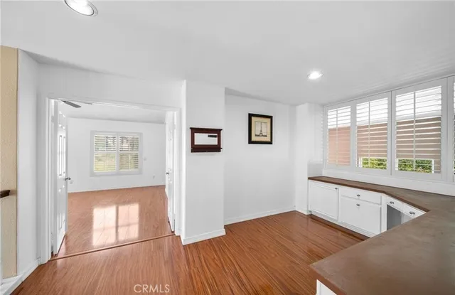 a view of a hallway with wooden floor and entryway