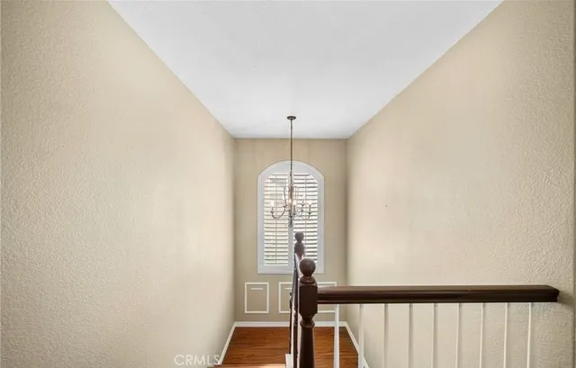 a view of a hallway with wooden floor and entryway