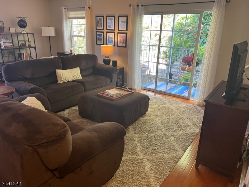 44 Ridgedale Avenue, Unit 1 Morristown, NJ 07960 - Photo 3 of 13 a living room with furniture and a flat screen tv