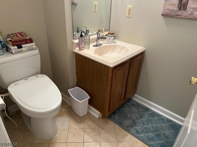 44 Ridgedale Avenue, Unit 1 Morristown, NJ 07960 - Photo 6 of 13 a bathroom with a sink toilet and a mirror