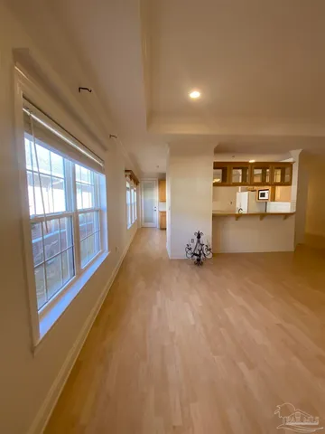 a big room with wooden floor and windows