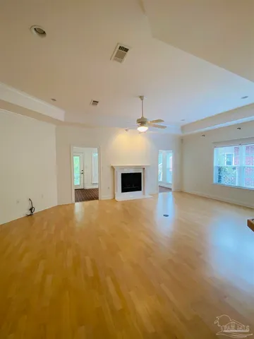 a view of a livingroom with a fireplace and a ceiling fan