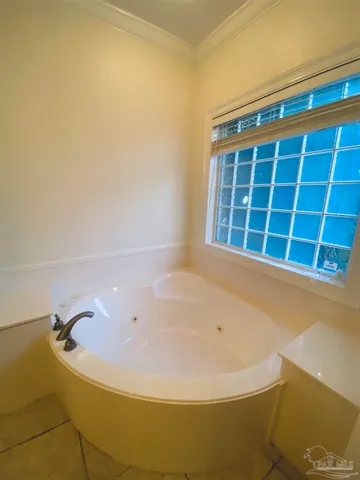 an empty room with a ceiling fan and a window