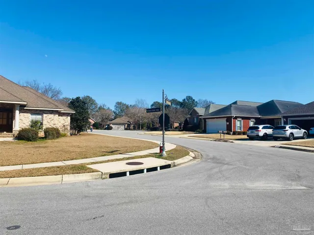 a view of a street with a house in the background
